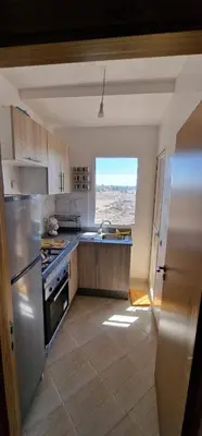 a kitchen with stainless steel appliances and a window at Bahia Sakan in Oulad Akkou