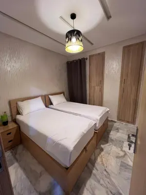 a bedroom with a large bed in a room at Luxury Appartement fes city fleur in Fès