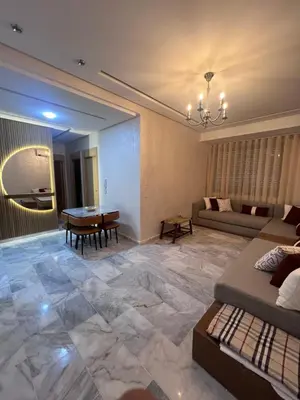 a living room with a couch and a table at Luxury Appartement fes city fleur in Fès