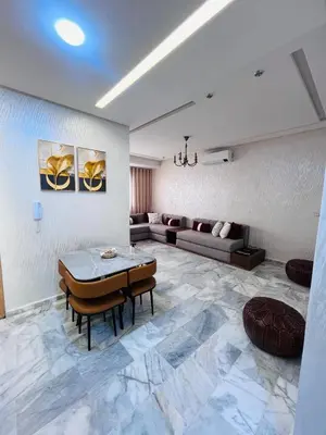a living room with a couch and a table at Luxury Appartement fes city fleur in Fès