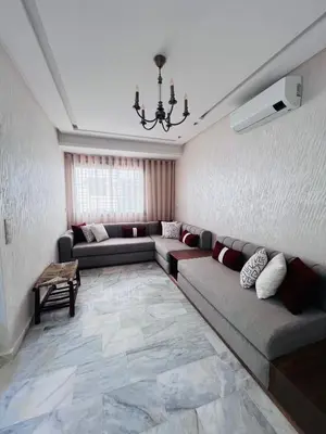 a living room with couches and a chandelier at Luxury Appartement fes city fleur in Fès