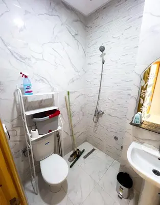 a bathroom with a toilet and a sink at Modern and quiet apartment in Beni Mellal