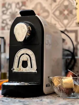a toaster sitting on a table next to a bowl of food at Modern and quiet apartment in Beni Mellal