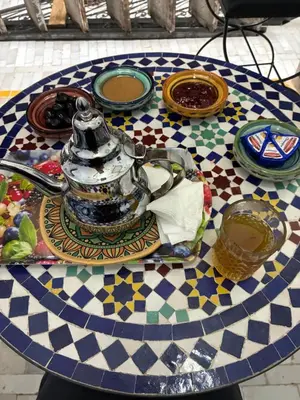 a table with a tea pot and plates on it at Riad Serendipity in Fès