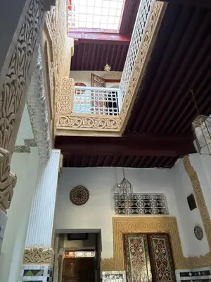 an ornate hallway of a building with wooden ceilings at Riad Serendipity in Fès