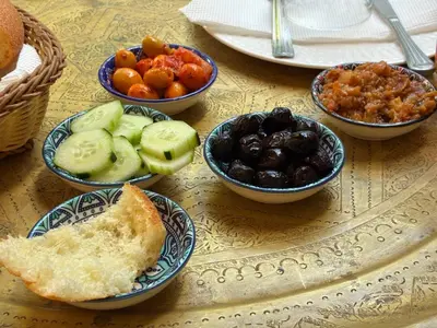 a table topped with bowls of different types of food at Riad Serendipity in Fès