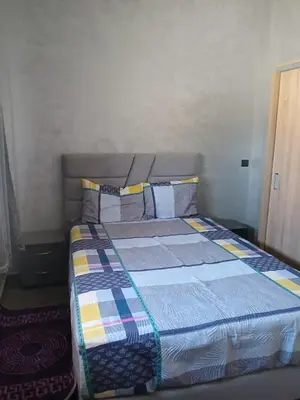 a bedroom with a bed with a colorful comforter at إقامة الخال للشقق المفروشة الرشدية in Er Rachidia