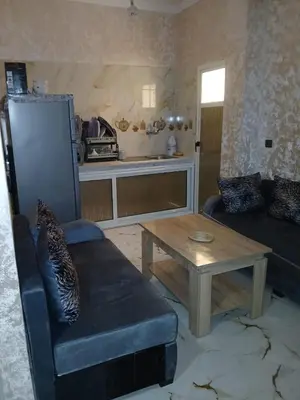 a living room with a couch and a coffee table at إقامة الخال للشقق المفروشة الرشدية in Er Rachidia