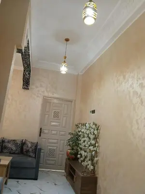 a living room with a door and a vase of flowers at إقامة الخال للشقق المفروشة الرشدية in Er Rachidia