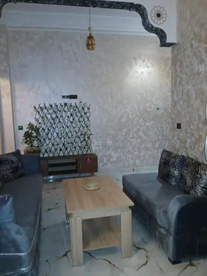 a living room with a couch and a coffee table at إقامة الخال للشقق المفروشة الرشدية in Er Rachidia