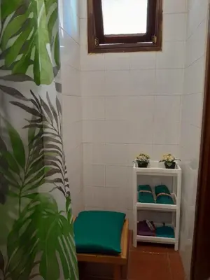 a bathroom with a green bench and a window at Centrical apartment in Ifrane forest and park view in Ifrane