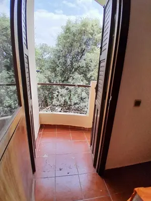 an open door to a balcony with a view at Centrical apartment in Ifrane forest and park view in Ifrane