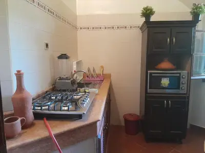 a kitchen with a stove and a counter top at Centrical apartment in Ifrane forest and park view in Ifrane