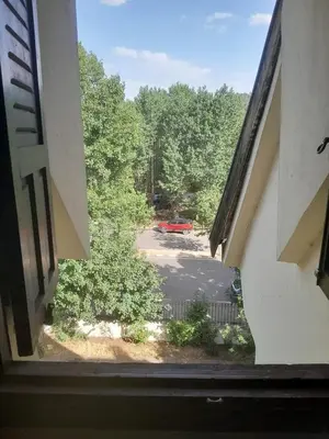 a view from a window of a parking lot at Centrical apartment in Ifrane forest and park view in Ifrane