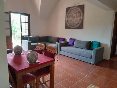 a living room with a couch and a table at Centrical apartment in Ifrane forest and park view in Ifrane