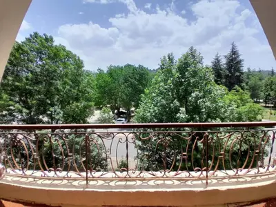 a balcony with a view of trees at Centrical apartment in Ifrane forest and park view in Ifrane