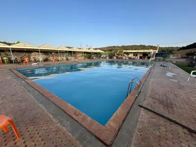 a large swimming pool with blue water at la maison d'autre Nadia in Sefrou