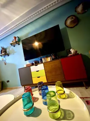 a living room with a table with glasses on it at cosy appartement calme in Oulad Akkou