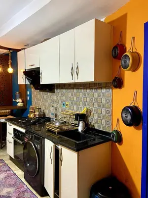 a kitchen with a sink and a stove top oven at cosy appartement calme in Oulad Akkou