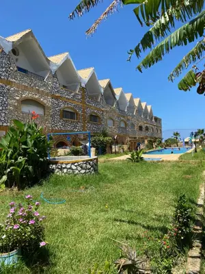 a large building with a yard and a pool at Maison villa in Oulad Akkou