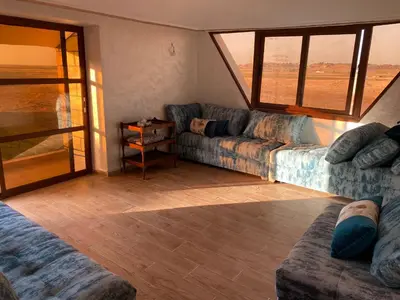 a living room with two couches and a window at Maison villa in Oulad Akkou