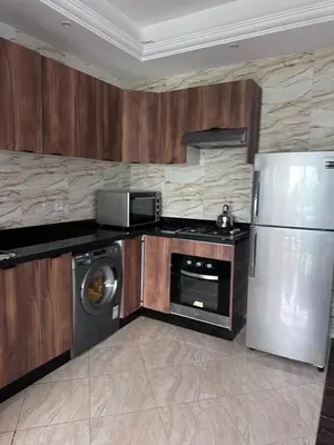 a kitchen with a refrigerator and a microwave at Appartment propre in Oulad Akkou