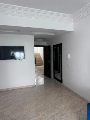 an empty room with white walls and tile floors at Appartment propre in Oulad Akkou