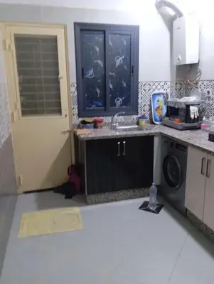 a kitchen with a sink and a washing machine at Residence de repos in Oulad Tayeb