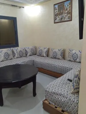 a living room with a couch and a table at Residence de repos in Oulad Tayeb