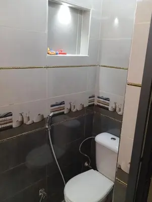 a bathroom with a toilet and a mirror at Residence de repos in Oulad Tayeb