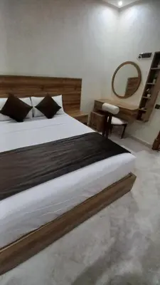 a bedroom with a large bed and a desk at Villa des Perles in Marrakech
