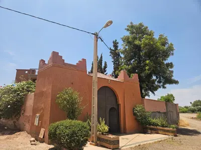 a red brick building with a street light at Villa des Perles in Marrakech