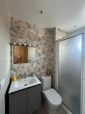 a bathroom with a toilet and a sink at Appartement in Oulad Akkou