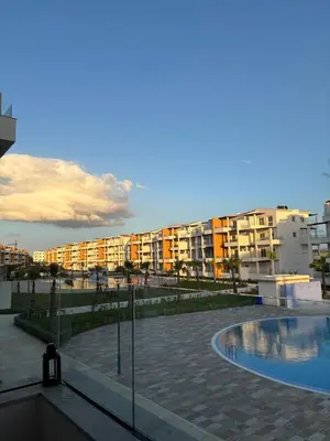 a swimming pool in front of some apartment buildings at Appartement in Oulad Akkou