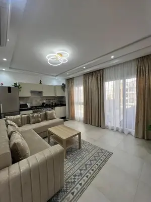 a living room with a couch and a table at Appartement in Oulad Akkou