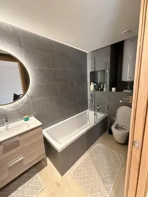 a bathroom with a white tub and a toilet at luxurious Taghazout duplex in Oulad Akkou