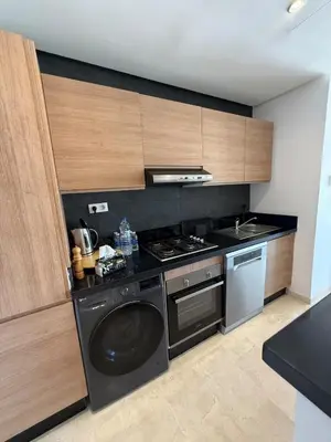 a kitchen with a stove and a dishwasher at luxurious Taghazout duplex in Oulad Akkou