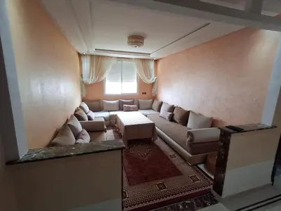 a living room with a couch and a table at yas appart in Oulad Akkou