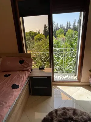 a bedroom with a bed and a large window at dar marwa in Fès