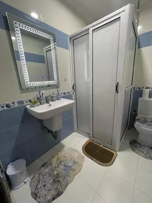 a bathroom with a sink and a shower with a mirror at dar marwa in Fès