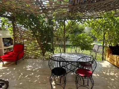 a patio with a table and chairs under a pergola at dar marwa in Fès
