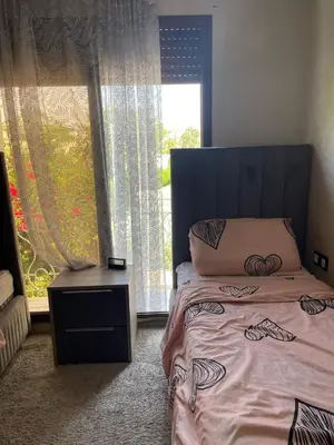 a bedroom with a bed and a large window at dar marwa in Fès