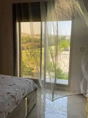 a bedroom with a bed and a view of a balcony at dar marwa in Fès