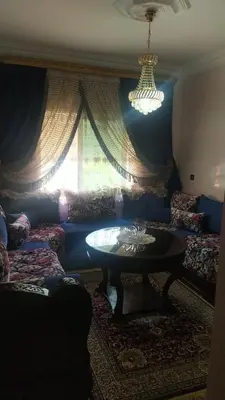 a living room with a couch and a table at Complexe OCEAN ATLANITIQUE in Oulad Akkou