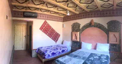 a bedroom with two beds in a room at Hotel KASBAH DADES MGOUN in Kalaat MGouna