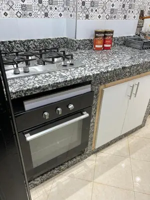 a kitchen with a stove and a counter top at cozy stay in Oulad Akkou