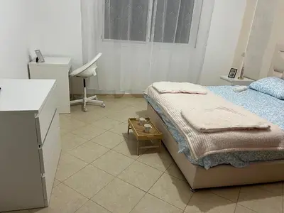 a bedroom with a bed and a desk and a window at cozy stay in Oulad Akkou