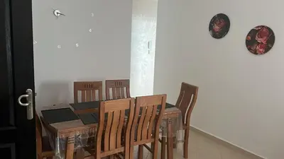 a dining room with a table and chairs at cozy stay in Oulad Akkou