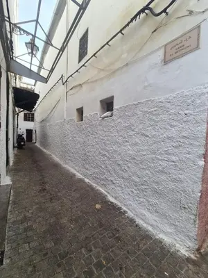 an empty hallway of a building with a stone wall at House Silya in Oulad Akkou