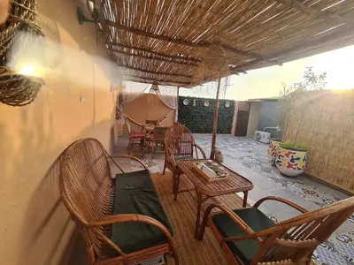 a patio with chairs and a table and a table and chairsearcher at House Silya in Oulad Akkou